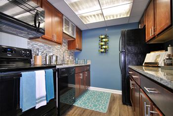 a kitchen with black appliances and a black refrigerator